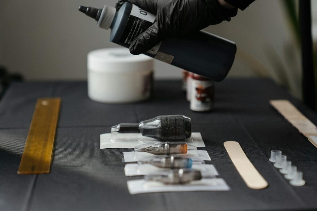 Close-up of tattoo equipment and ink in a tattoo studio, showcasing tools and preparation.